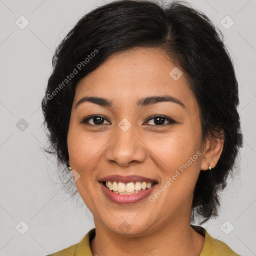 Joyful latino young-adult female with medium  brown hair and brown eyes