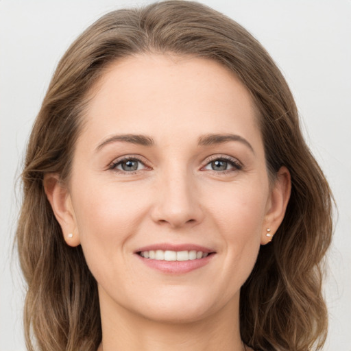 Joyful white young-adult female with long  brown hair and grey eyes