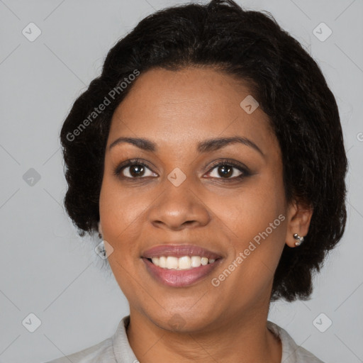 Joyful black young-adult female with short  black hair and brown eyes