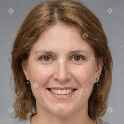 Joyful white adult female with medium  brown hair and grey eyes