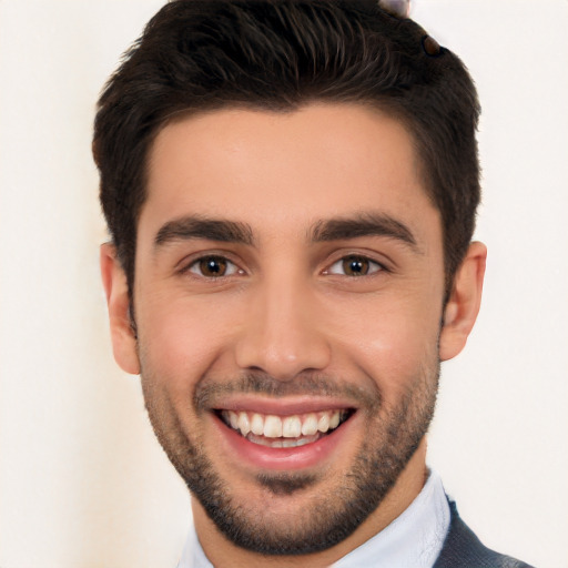 Joyful white young-adult male with short  black hair and brown eyes