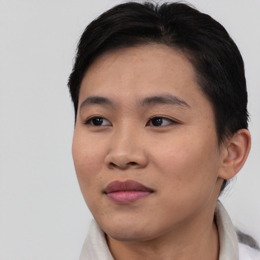 Joyful asian young-adult female with short  brown hair and brown eyes
