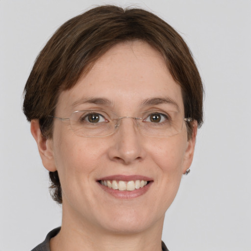 Joyful white adult female with medium  brown hair and grey eyes