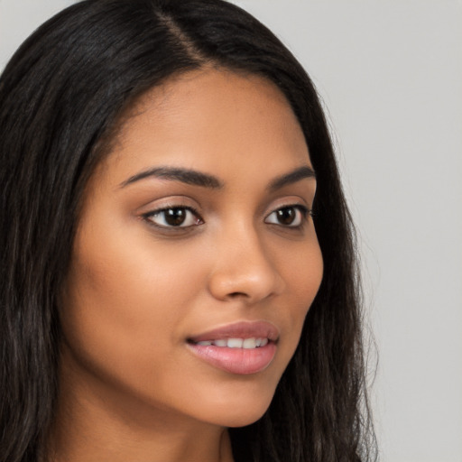 Joyful latino young-adult female with long  brown hair and brown eyes