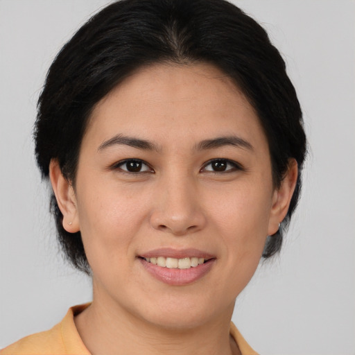 Joyful asian young-adult female with medium  brown hair and brown eyes