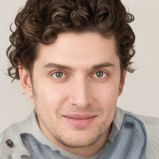 Joyful white young-adult male with short  brown hair and blue eyes