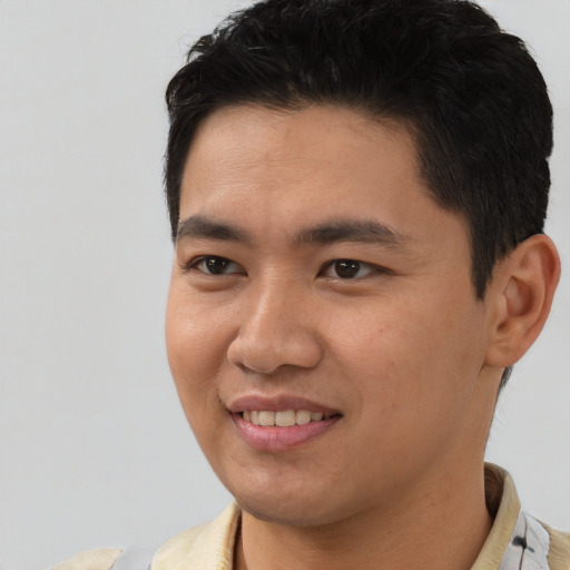 Joyful latino young-adult male with short  black hair and brown eyes