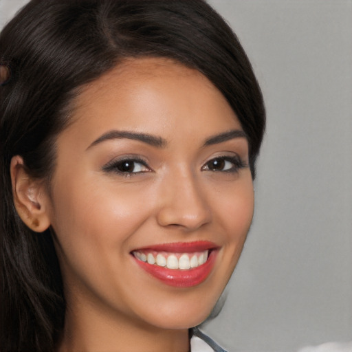 Joyful latino young-adult female with long  brown hair and brown eyes