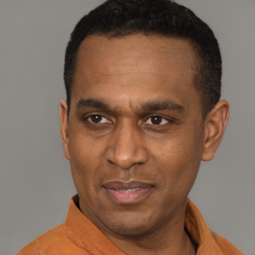 Joyful latino adult male with short  black hair and brown eyes