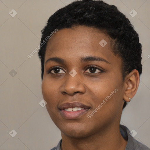 Joyful black young-adult female with short  black hair and brown eyes