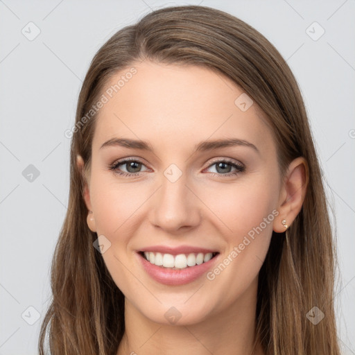 Joyful white young-adult female with long  brown hair and grey eyes