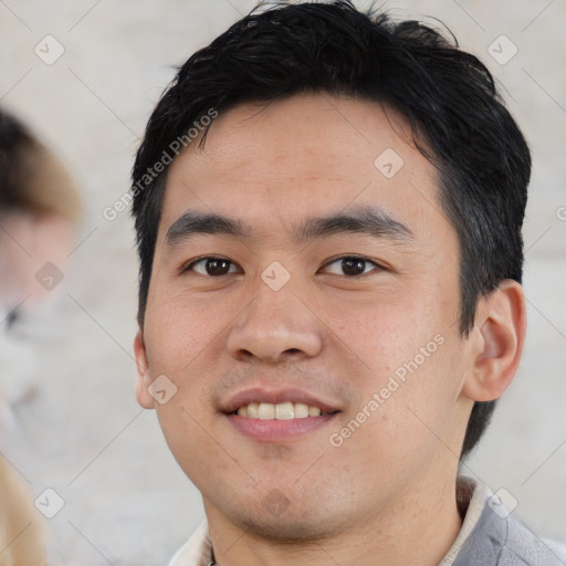 Joyful asian young-adult male with short  black hair and brown eyes