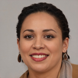 Joyful latino young-adult female with long  brown hair and brown eyes