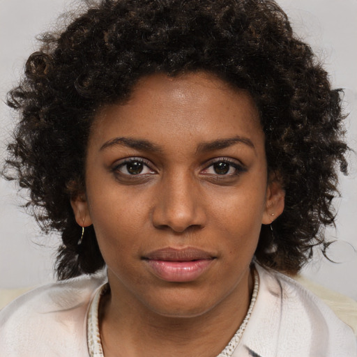 Joyful black young-adult female with medium  brown hair and brown eyes