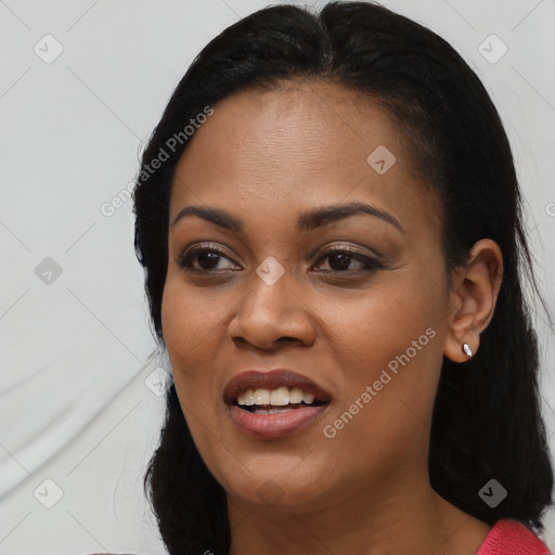 Joyful black young-adult female with long  black hair and brown eyes