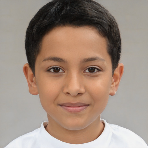 Joyful latino child male with short  brown hair and brown eyes
