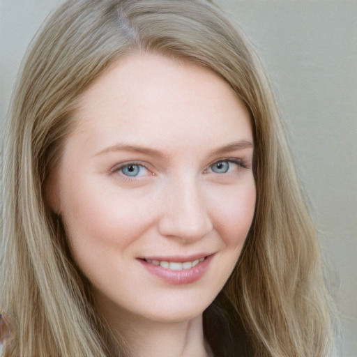 Joyful white young-adult female with long  brown hair and blue eyes