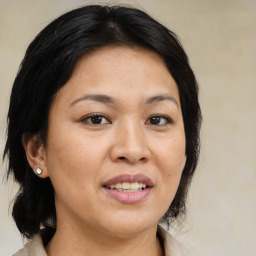 Joyful asian adult female with medium  brown hair and brown eyes