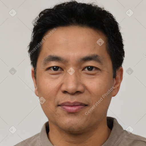 Joyful asian adult male with short  black hair and brown eyes