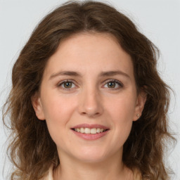 Joyful white young-adult female with medium  brown hair and green eyes