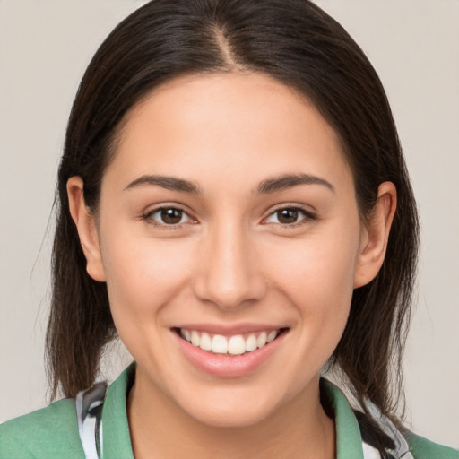 Joyful white young-adult female with medium  brown hair and brown eyes