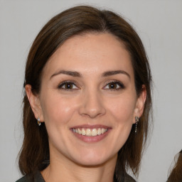 Joyful white young-adult female with medium  brown hair and brown eyes