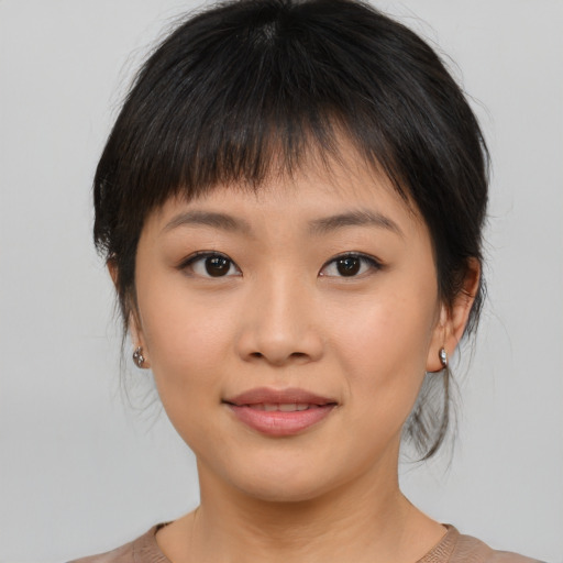 Joyful asian young-adult female with medium  brown hair and brown eyes