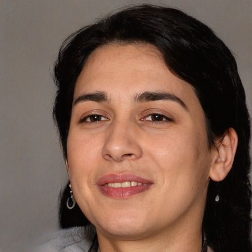 Joyful white young-adult female with medium  black hair and brown eyes