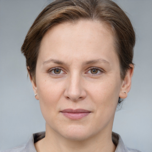 Joyful white adult female with short  brown hair and grey eyes