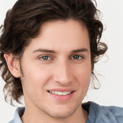 Joyful white young-adult male with medium  brown hair and brown eyes