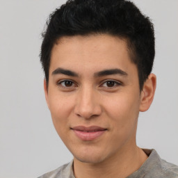 Joyful latino young-adult male with short  brown hair and brown eyes