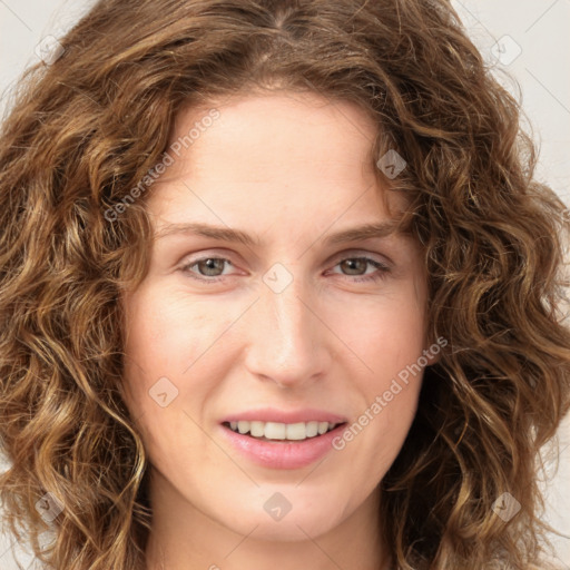 Joyful white young-adult female with long  brown hair and green eyes