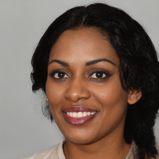 Joyful black young-adult female with medium  black hair and brown eyes