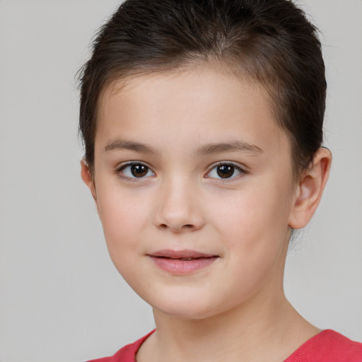 Joyful white child female with short  brown hair and brown eyes