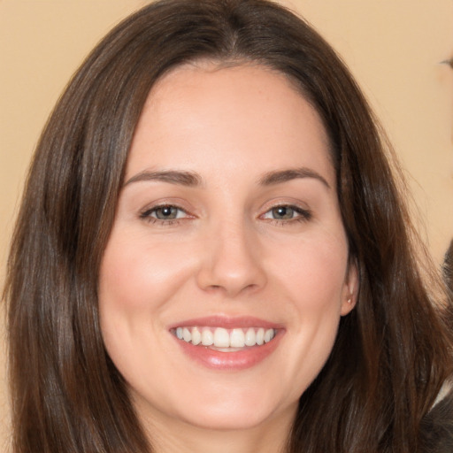 Joyful white young-adult female with long  brown hair and brown eyes