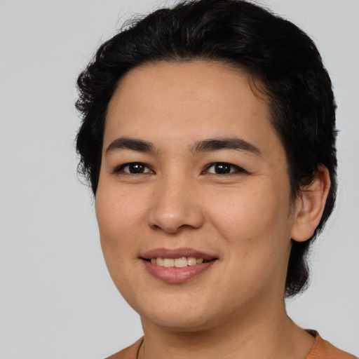 Joyful asian young-adult female with short  black hair and brown eyes