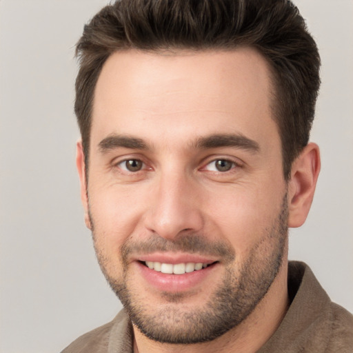 Joyful white young-adult male with short  brown hair and brown eyes