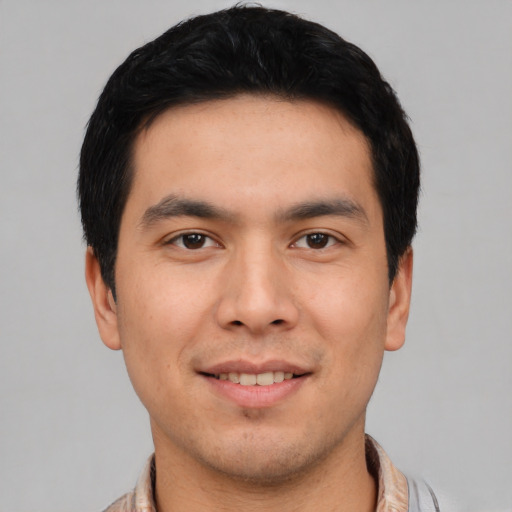 Joyful asian young-adult male with short  black hair and brown eyes