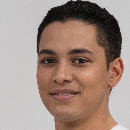 Joyful latino young-adult male with short  black hair and brown eyes