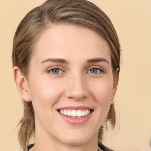 Joyful white young-adult female with medium  brown hair and green eyes