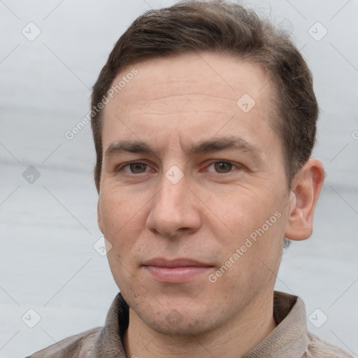 Joyful white adult male with short  brown hair and grey eyes