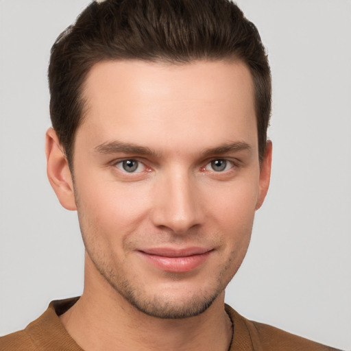 Joyful white young-adult male with short  brown hair and grey eyes