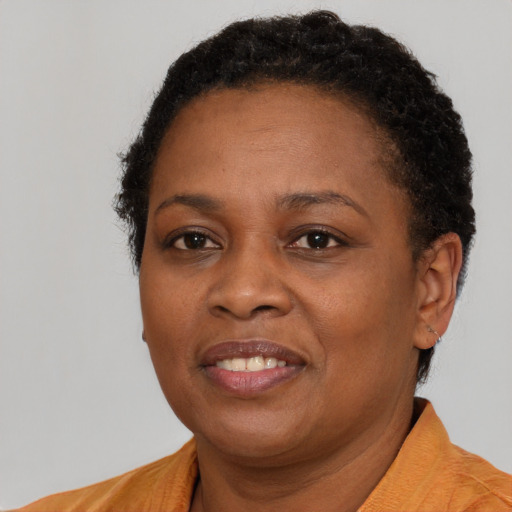 Joyful black adult female with short  brown hair and brown eyes