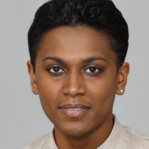 Joyful black young-adult female with short  black hair and brown eyes