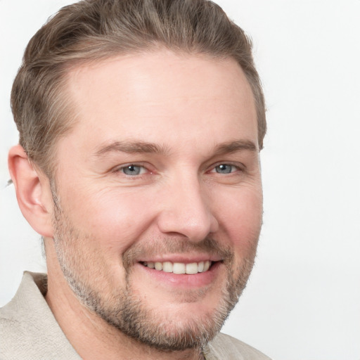 Joyful white adult male with short  brown hair and grey eyes