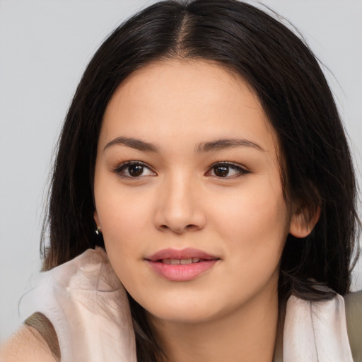 Joyful asian young-adult female with long  brown hair and brown eyes