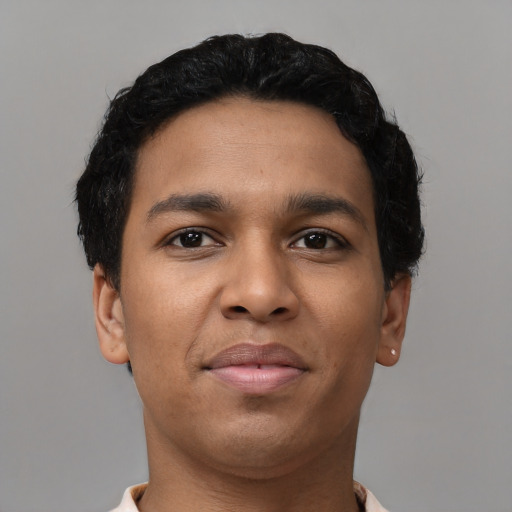 Joyful latino young-adult male with short  brown hair and brown eyes