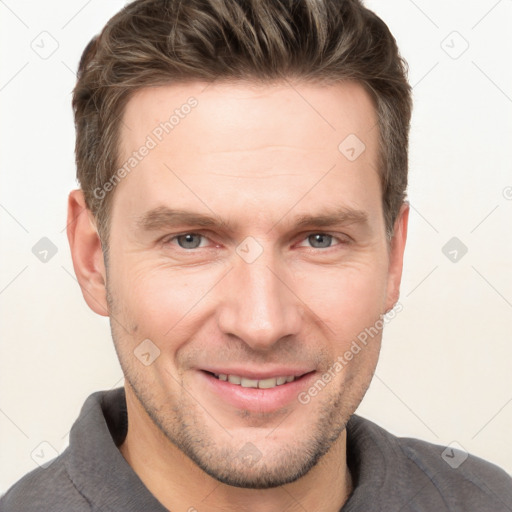 Joyful white adult male with short  brown hair and grey eyes