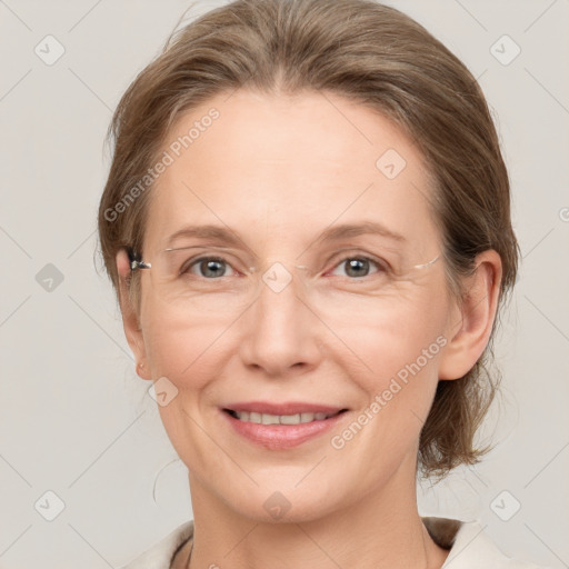 Joyful white adult female with medium  brown hair and grey eyes