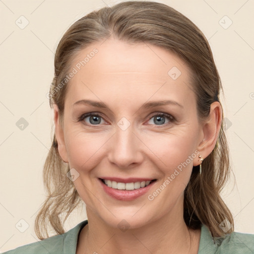 Joyful white young-adult female with medium  brown hair and blue eyes